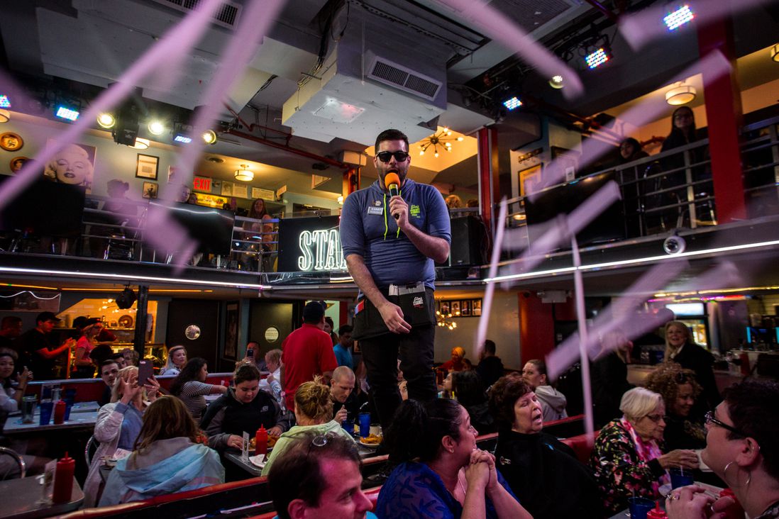 Danny Brooks, who has served at Stardust Diner since 2015, tosses straws into the air while singing "New York, New York."</br>